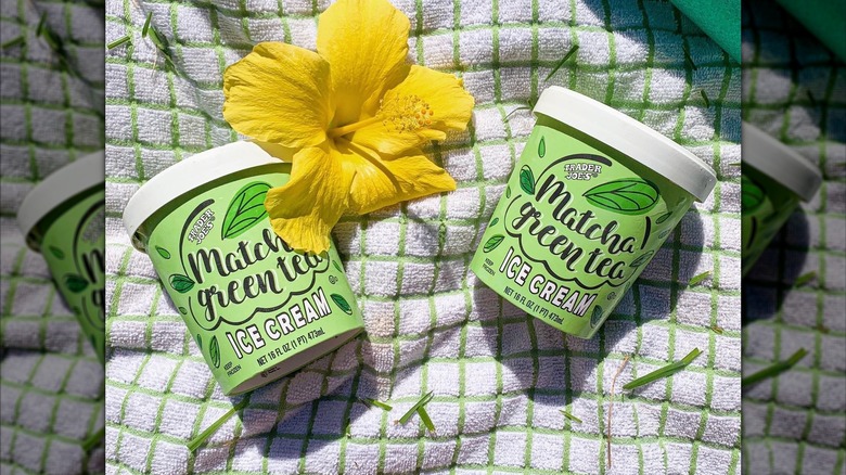 Two pints of Trader Joe's Matcha Green Tea Ice Cream with a yellow flower.