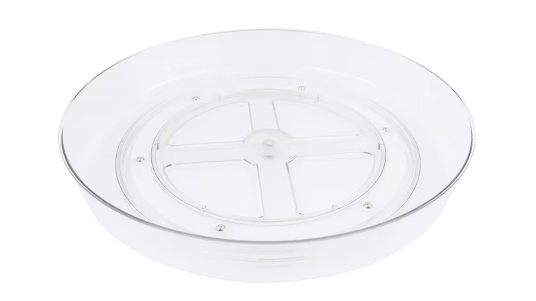 A clear plastic lazy Susan-style turntable
