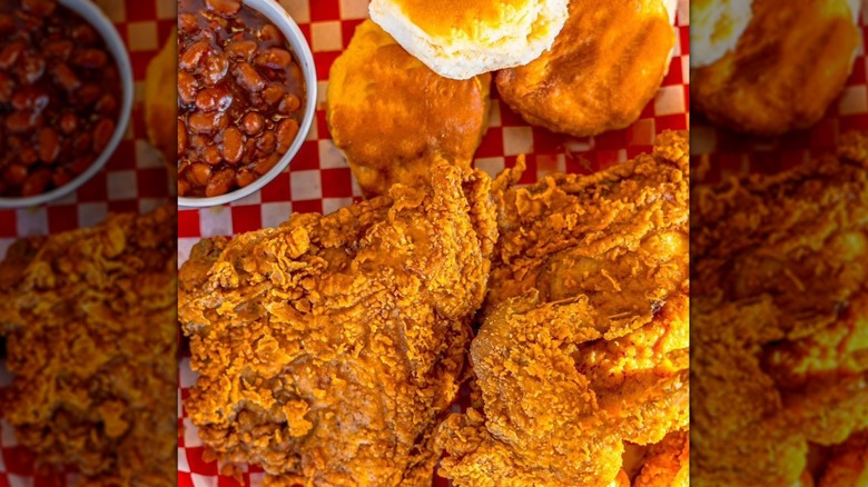 Lee's Famous Fried Chicken with Biscuits and Beans on a red checkered material