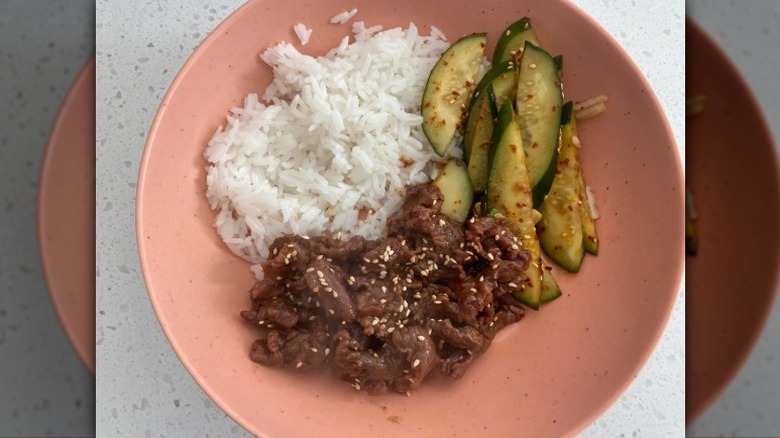 A plate of Beef Bulgogi by Trader Joe's with white rice and cucumbers