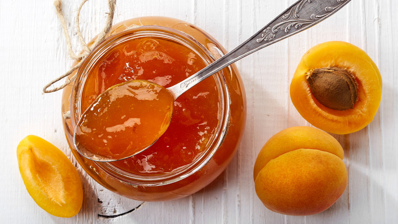 Apricot jam alongside apricots.