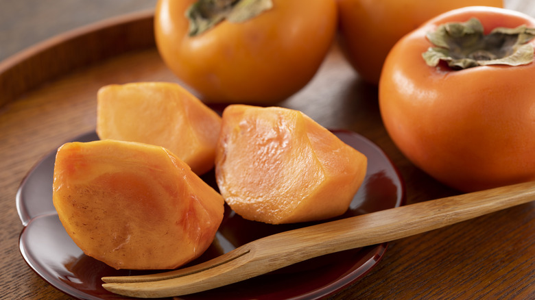 Sliced and whole persimmons.