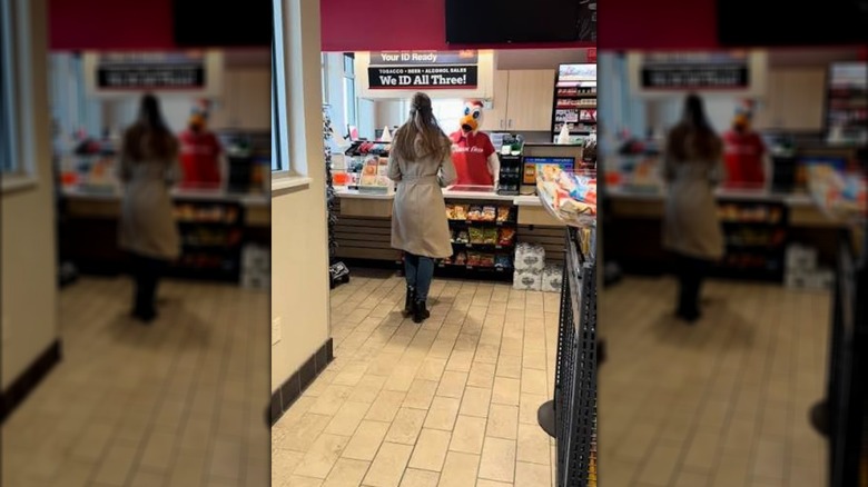 A woman orders from a duck mascot at a Kwik Trip counter