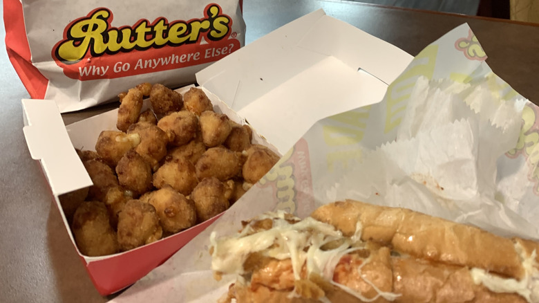 A Rutter's sub with chicken bites in front of a Rutter's bag