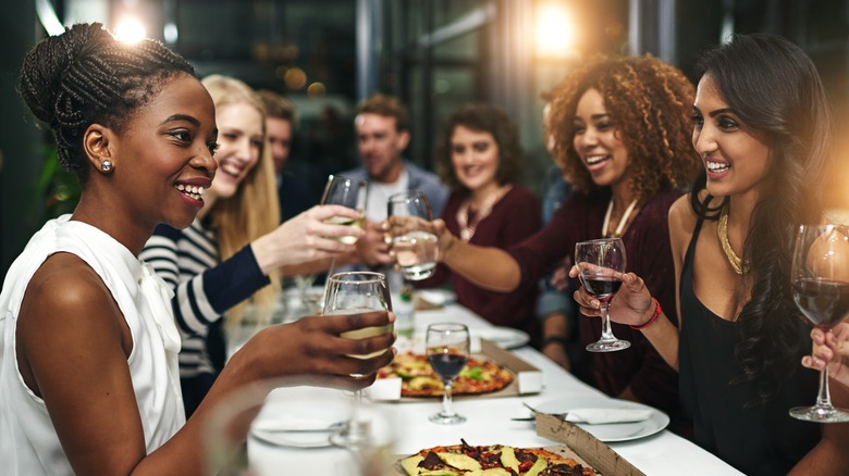 Friends smiling around dinner table