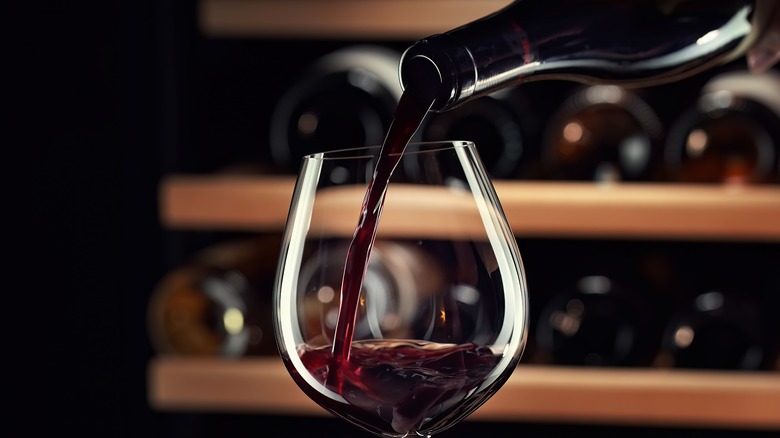 Bottle of red wine being poured