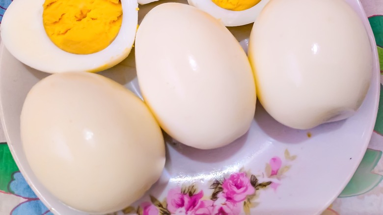 halved and whole hard-boiled eggs on a plate