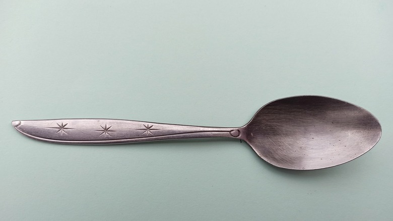 silver spoon on a blue background