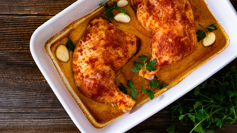 Chicken marinating in a baking dish