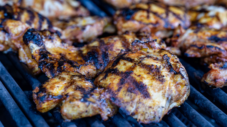 Charred chicken thighs on the grill