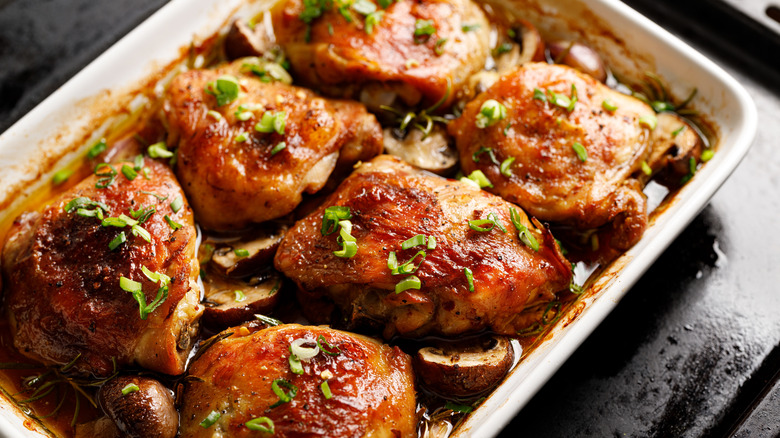 Chicken thighs with mushrooms and scallions in a baking dish