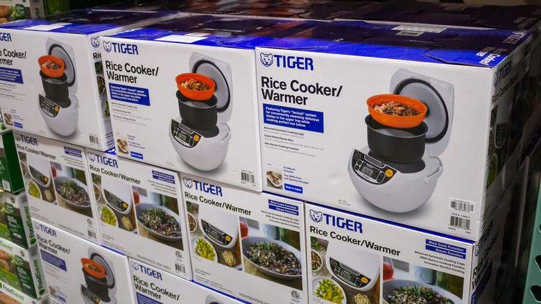 several boxes of Tiger Rice Cooker and Warmer stacked on retail shelf