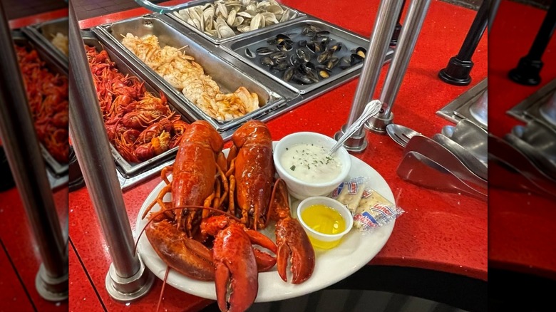 Lobster on a plate with butter and sauce at the buffet
