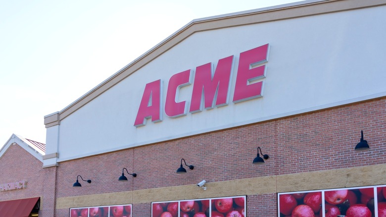 ACME Markets storefront with posters of apples on the building