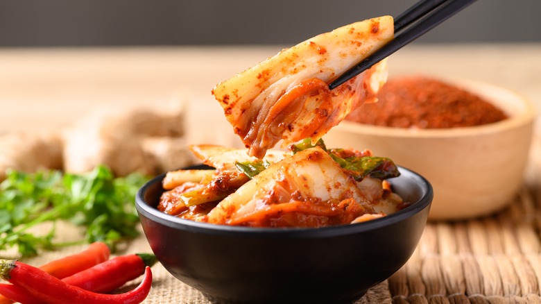 kimchi held with chopsticks