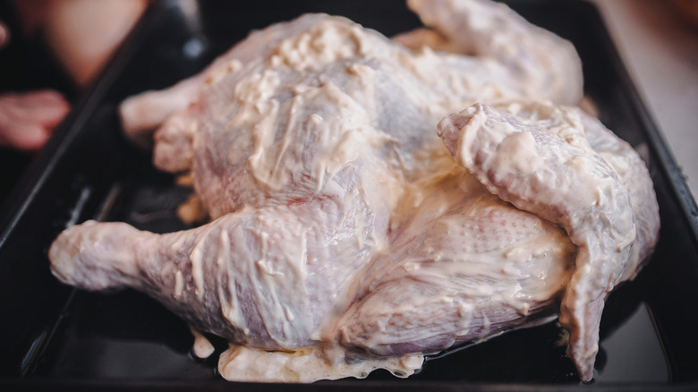 Raw chicken coated in mayonnaise