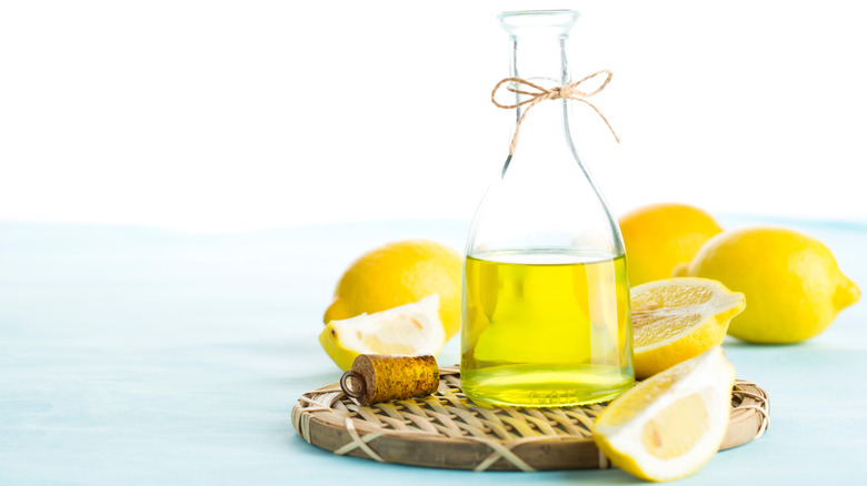 Fresh lemons and olive oil on a whicker mat