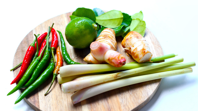 Selection of Vietnamese ingredients, including lemongrass, lime, and chile