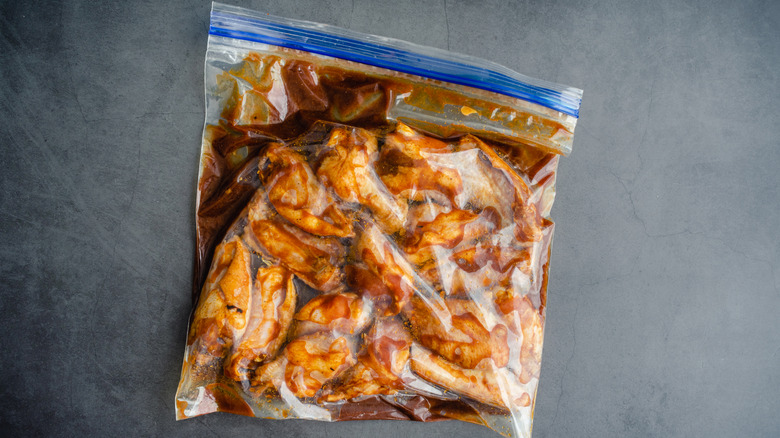 Chicken wings marinating in a resealable bag