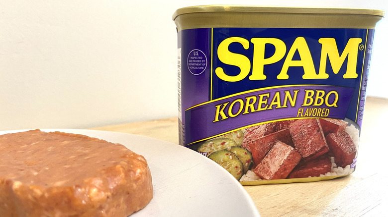 Slice of Spam Korean BBQ Flavored on a plate next to the can.
