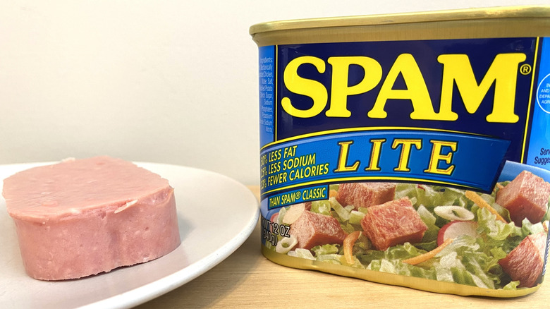 Slice of Spam Lite on a plate next to the can.