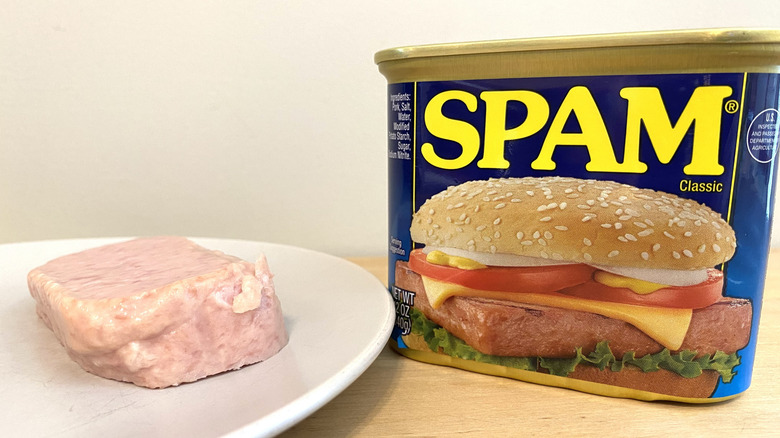 Slice of Spam Classic on a plate next to the can.