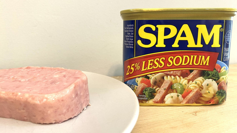 Slice of Spam 25% Less Sodium on a plate next to the can.