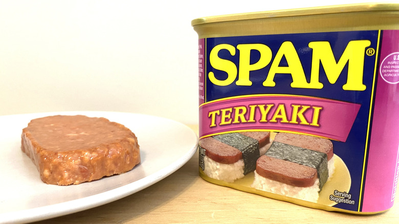 Slice of Spam Teriyaki on a plate next to the can.