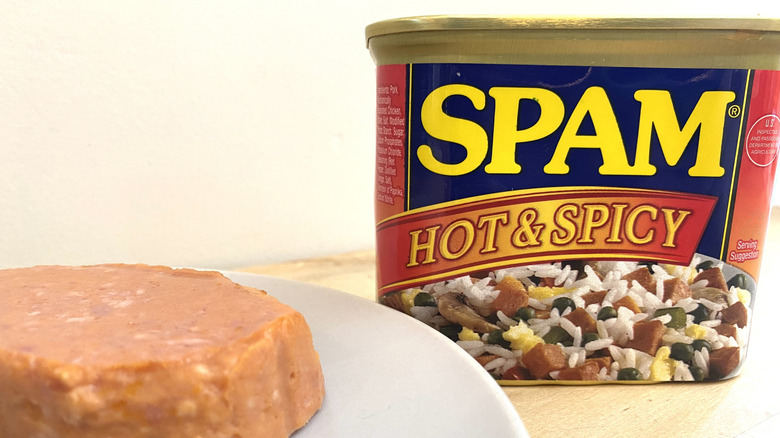 Slice of Spam Hot and Spicy on a plate next to the can.