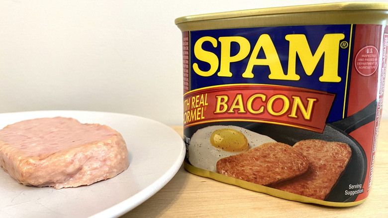Slice of Spam with Real Hormel Bacon on a plate next to the can.