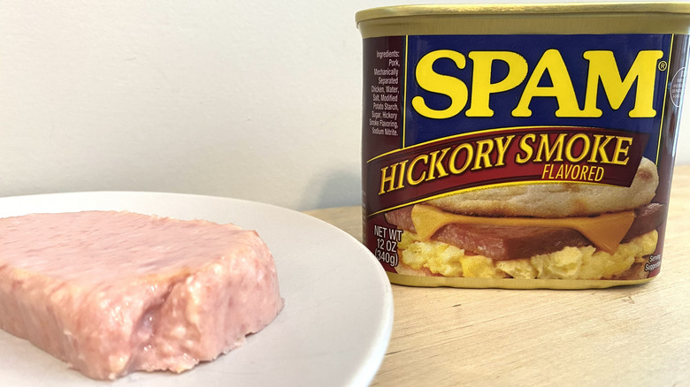 Slice of Spam Hickory Smoke Flavored on a plate next to the can.