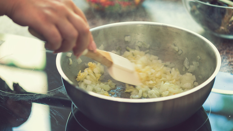 Diced onions being cooked on stovetop