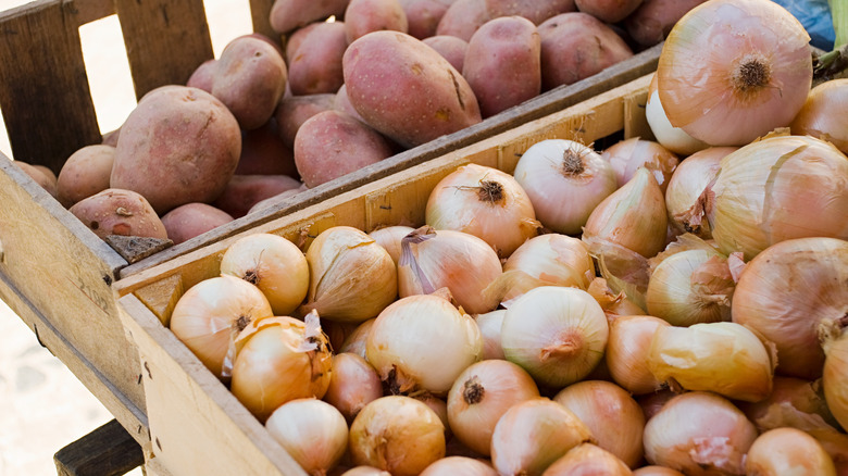 Wooden crates of onions and potatoes