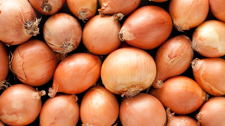 Overhead texture shot of whole brown onions