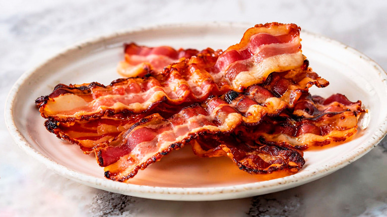 white plate of bacon slices
