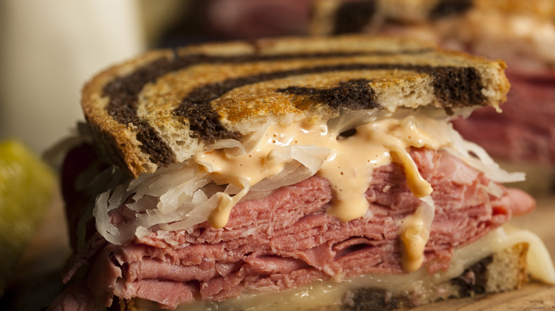 super-sized pastrami sandwich on a white plate