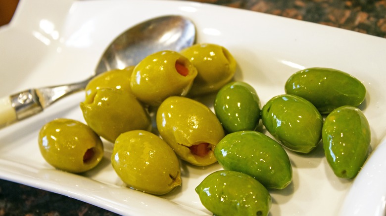 green olives on a white plate