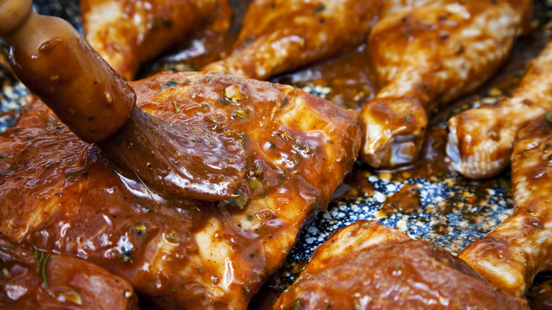 applying sauce on meat