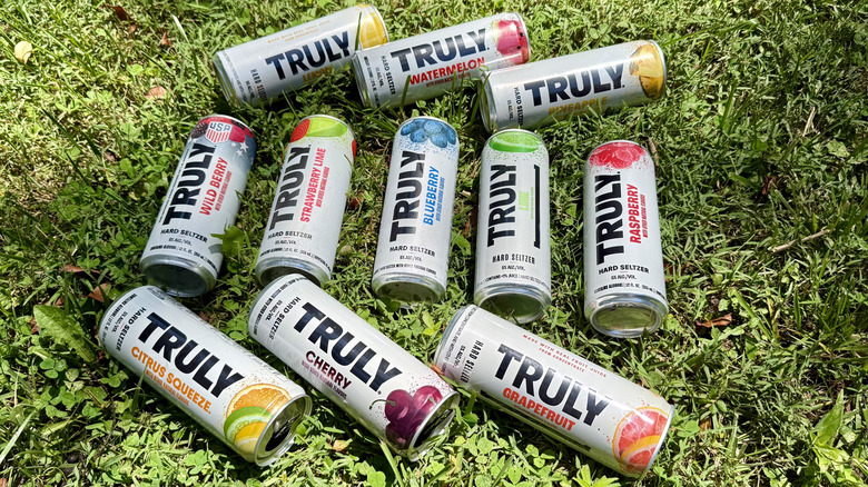 11 cans of Truly seltzer arranged on the grass