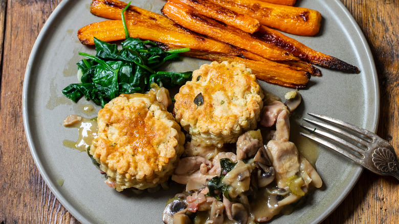 chicken cobbler on a plate with a side of carrots