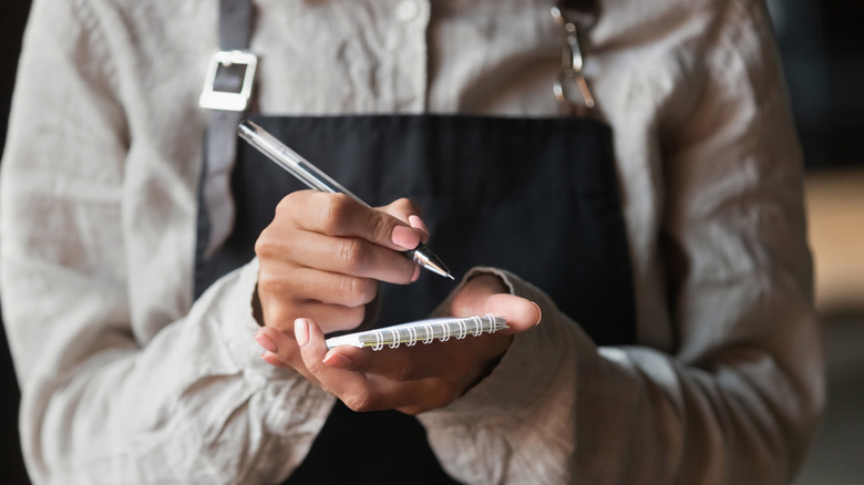 Server with notepad and pen