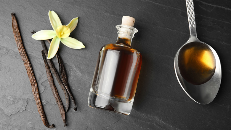 Vanilla extract bottle next to spoon