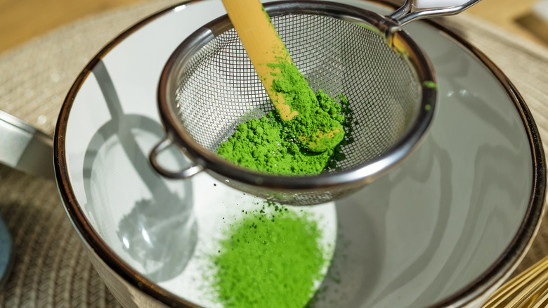 Matcha being sifted into a bowl