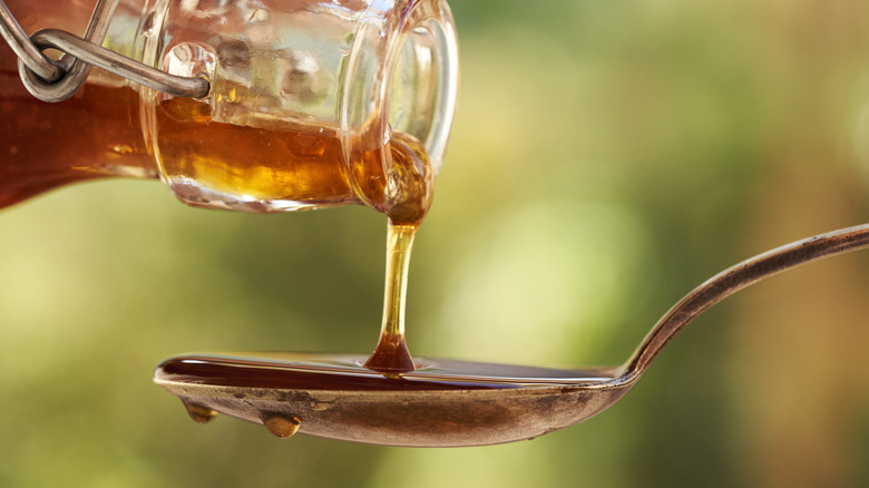 Honey being poured onto a spoon
