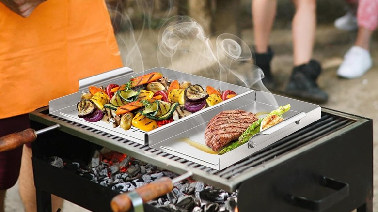 Vegetables and meat cooking on an Onlyfire grill tray.