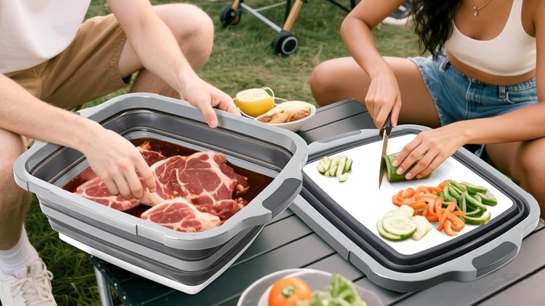 Two people prep food on a Meegoo﻿ tub for the grill.
