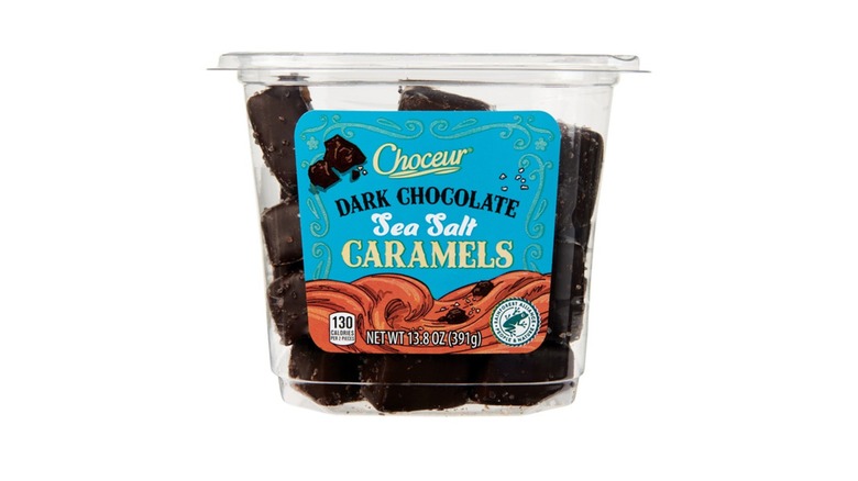 A see-through plastic container of Choceur Dark Chocolate Sea Salt Caramels from Aldi