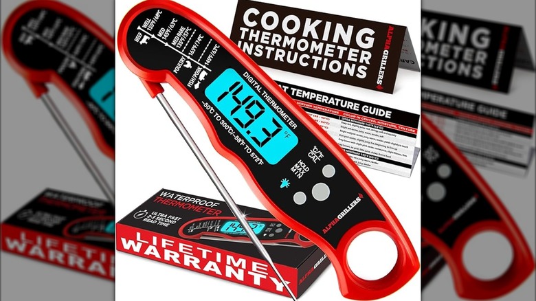 A high-resolution photo of a red meat thermometer.