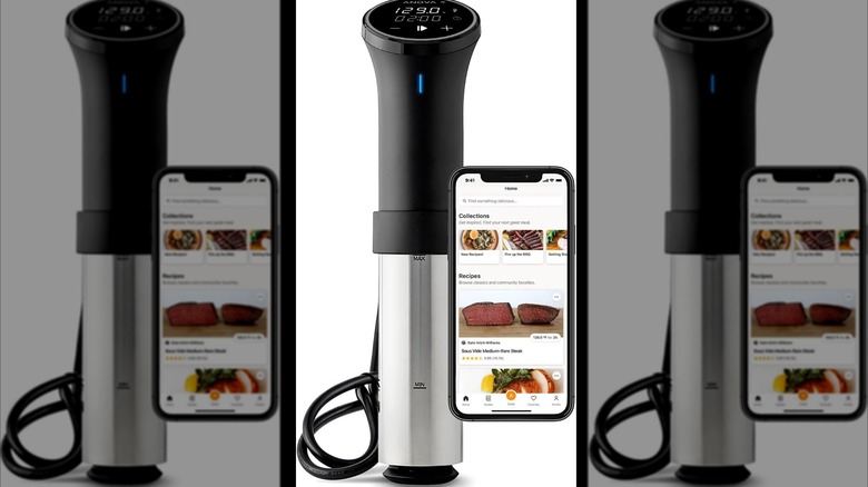 A sous vide machine next to an open phone app.
