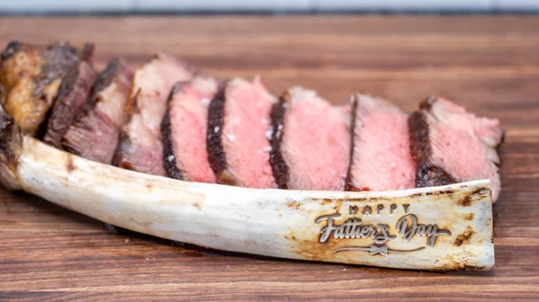 Custom engraved Tomahawk steak bone that says 'Happy Father's Day'